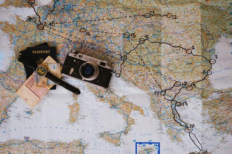 A travel map and camera on a map. Explore new destinations and capture memories