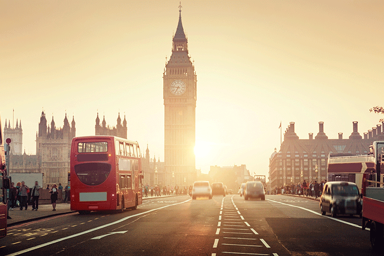 A city street with a clock tower in London, showcasing the urban charm and timeless beauty