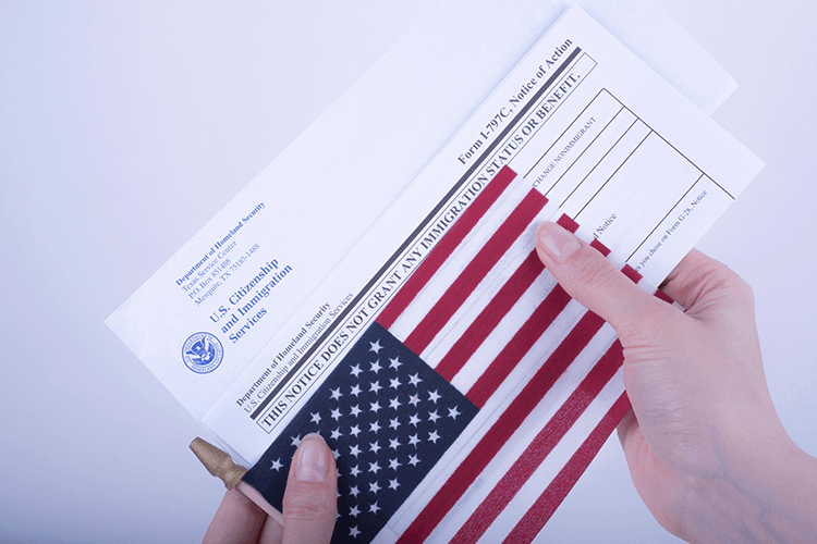 A person holding a document and an American flag, symbolizing travel and patriotism
