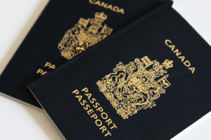 Two Canadian passports on a white surface