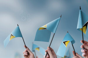 Hands holding flags of the Saint Lucia, symbolizing national pride and unity